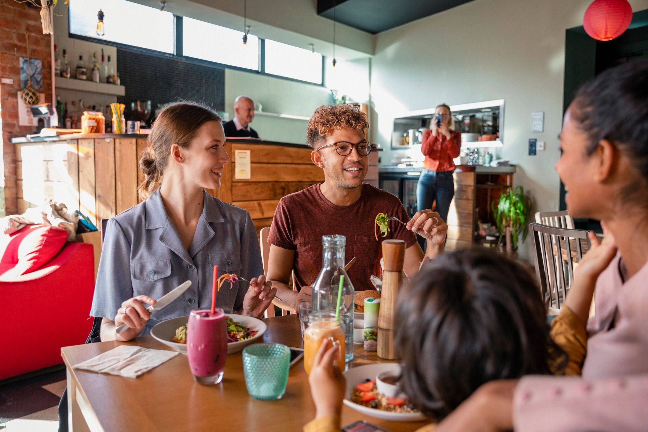 Friends dining together representing a positive mall visit