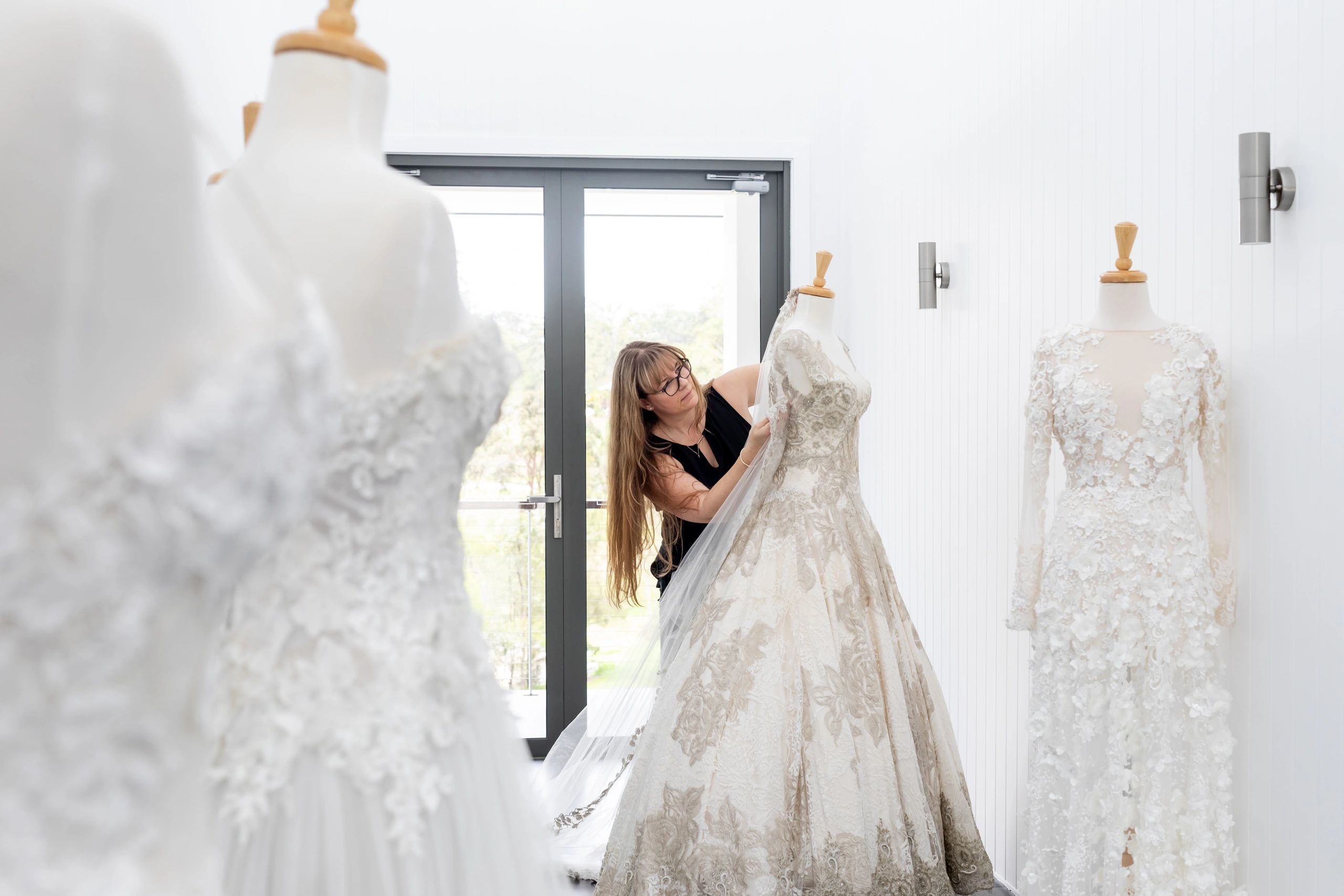 Fashion designer working on a bridal gown in a studio