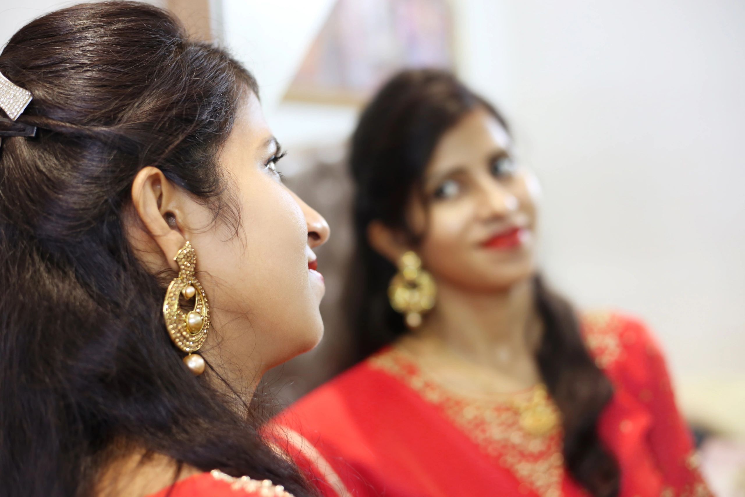 Woman getting ready in front of mirror representing makeover services
