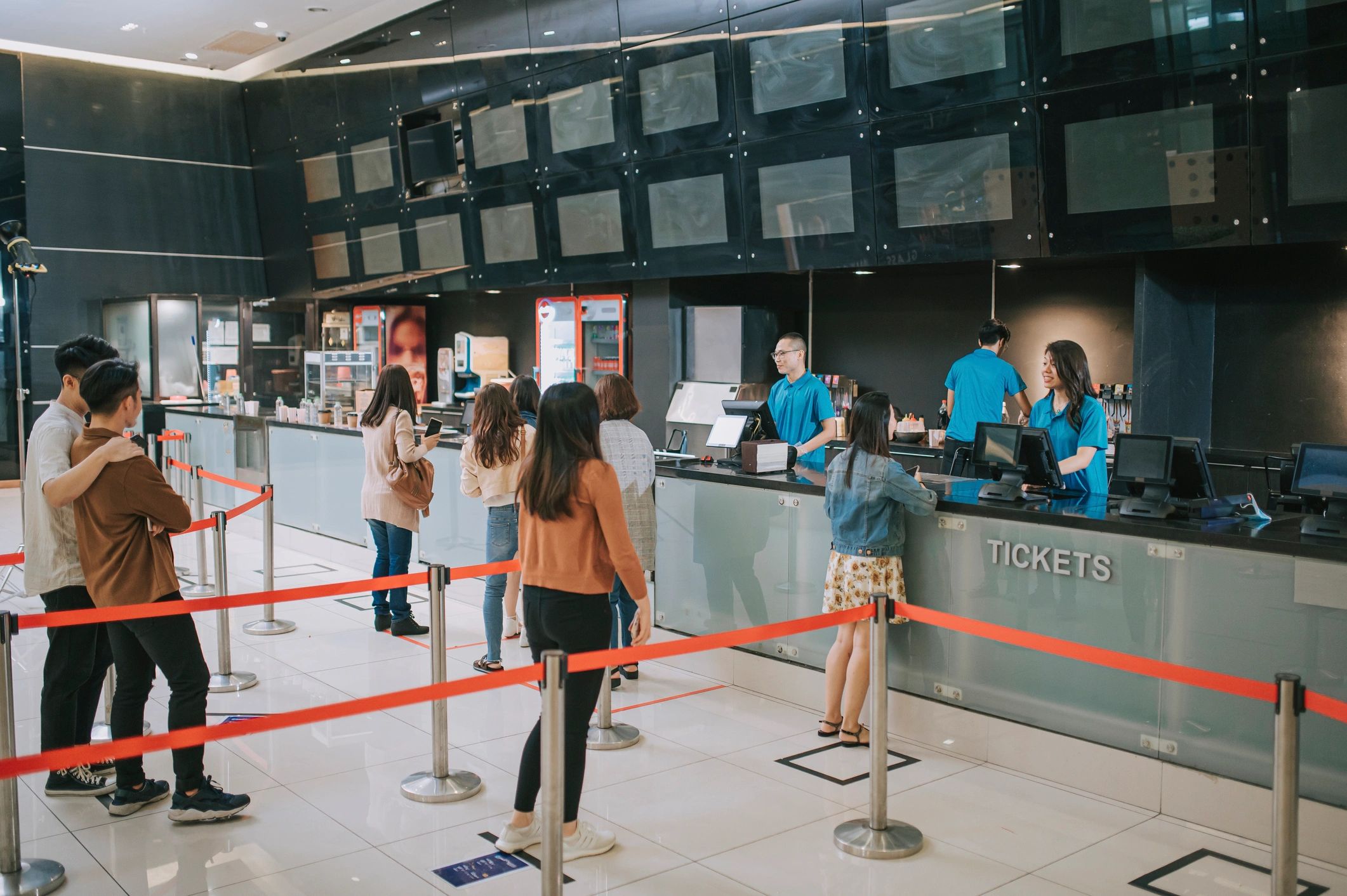 Cinema lobby ticket counter with customers