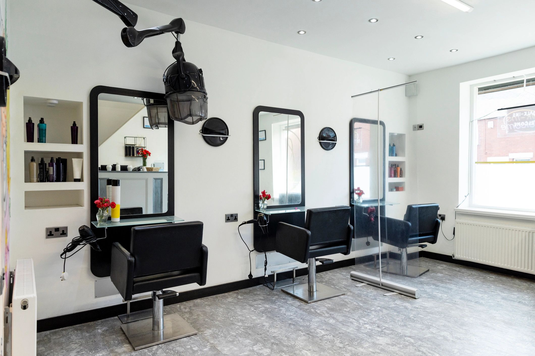 Salon interior with styling station and protective screen