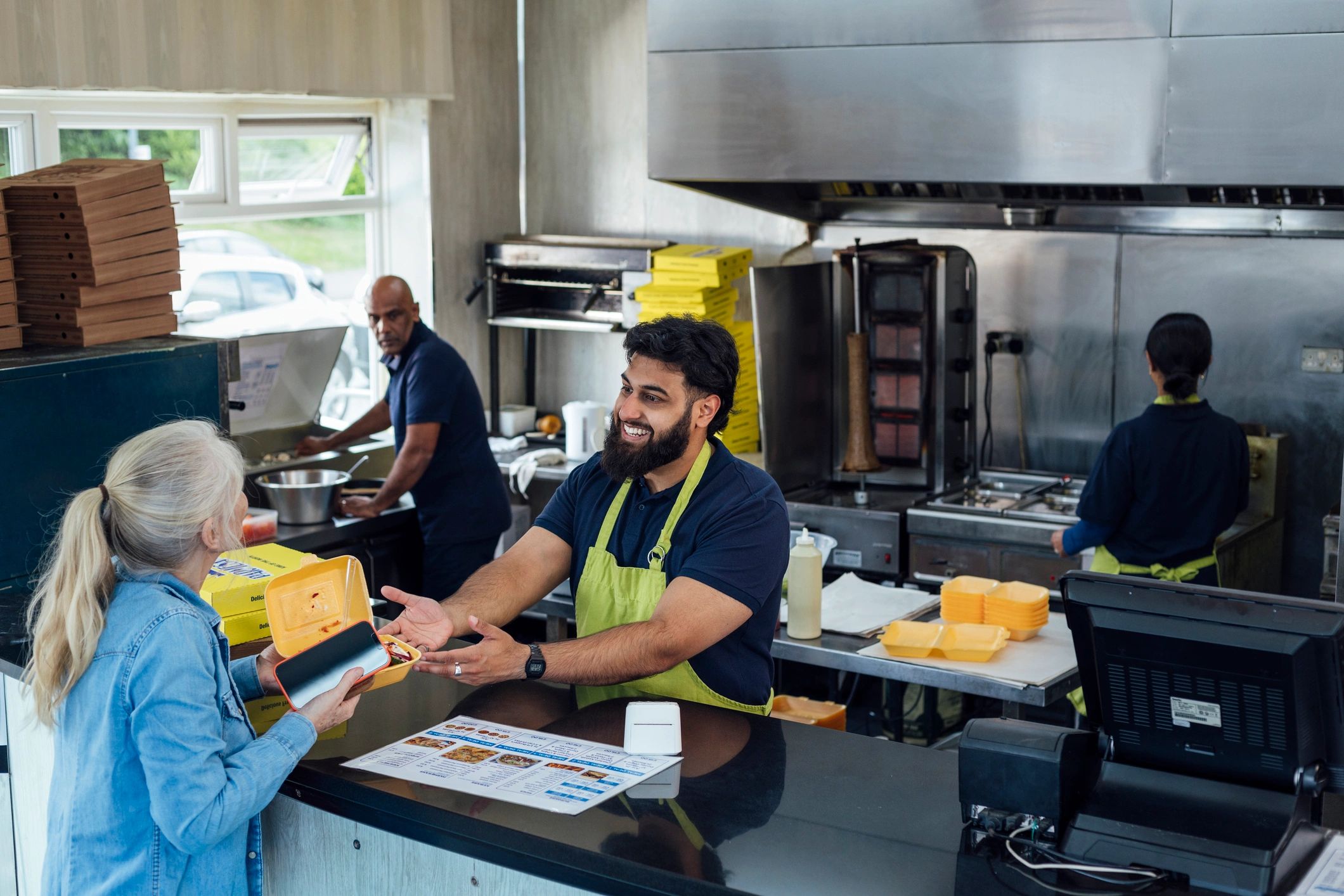 Store staff serving customers at checkout