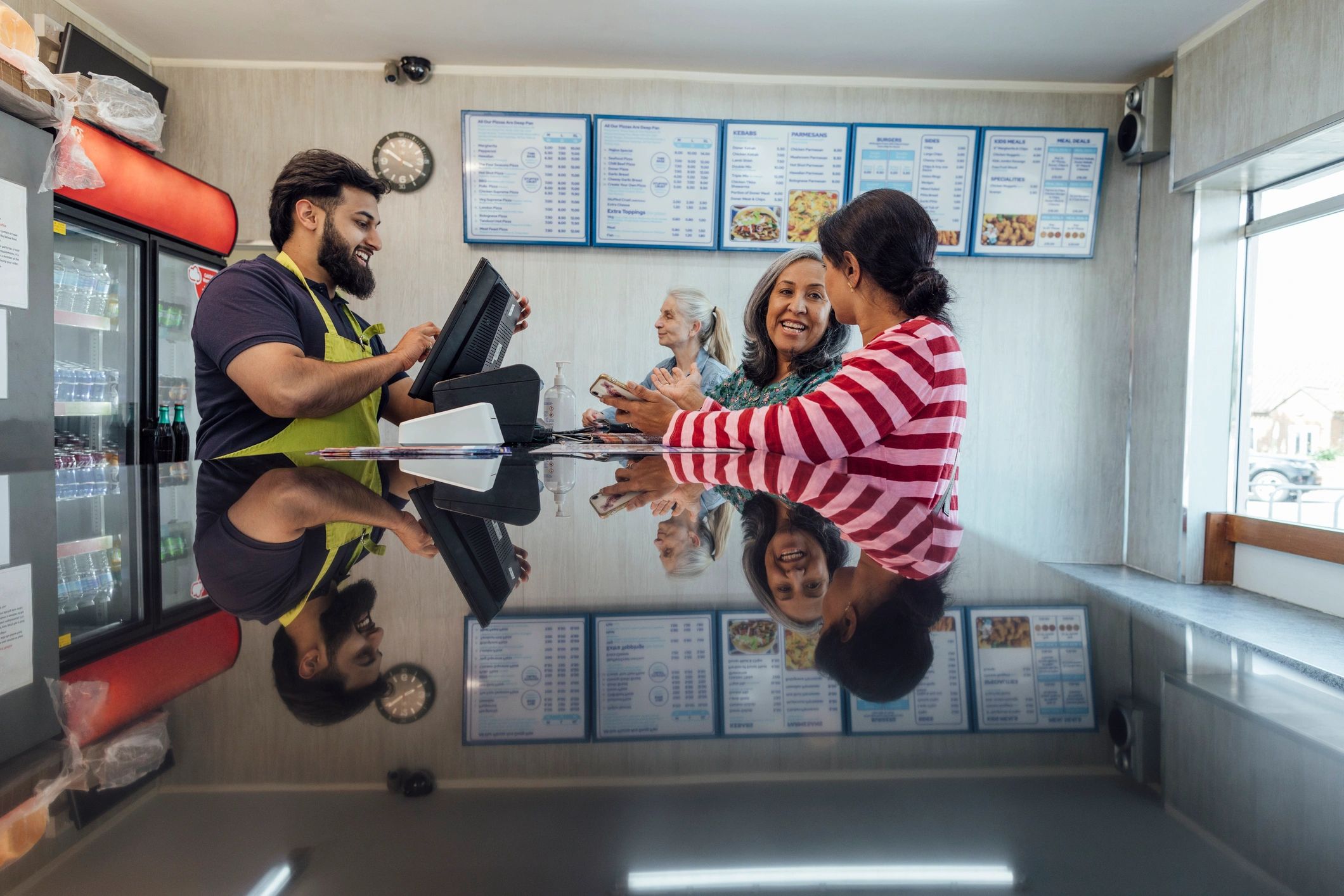 Customers at a retail counter representing Fiowmart's welcoming shopping experience