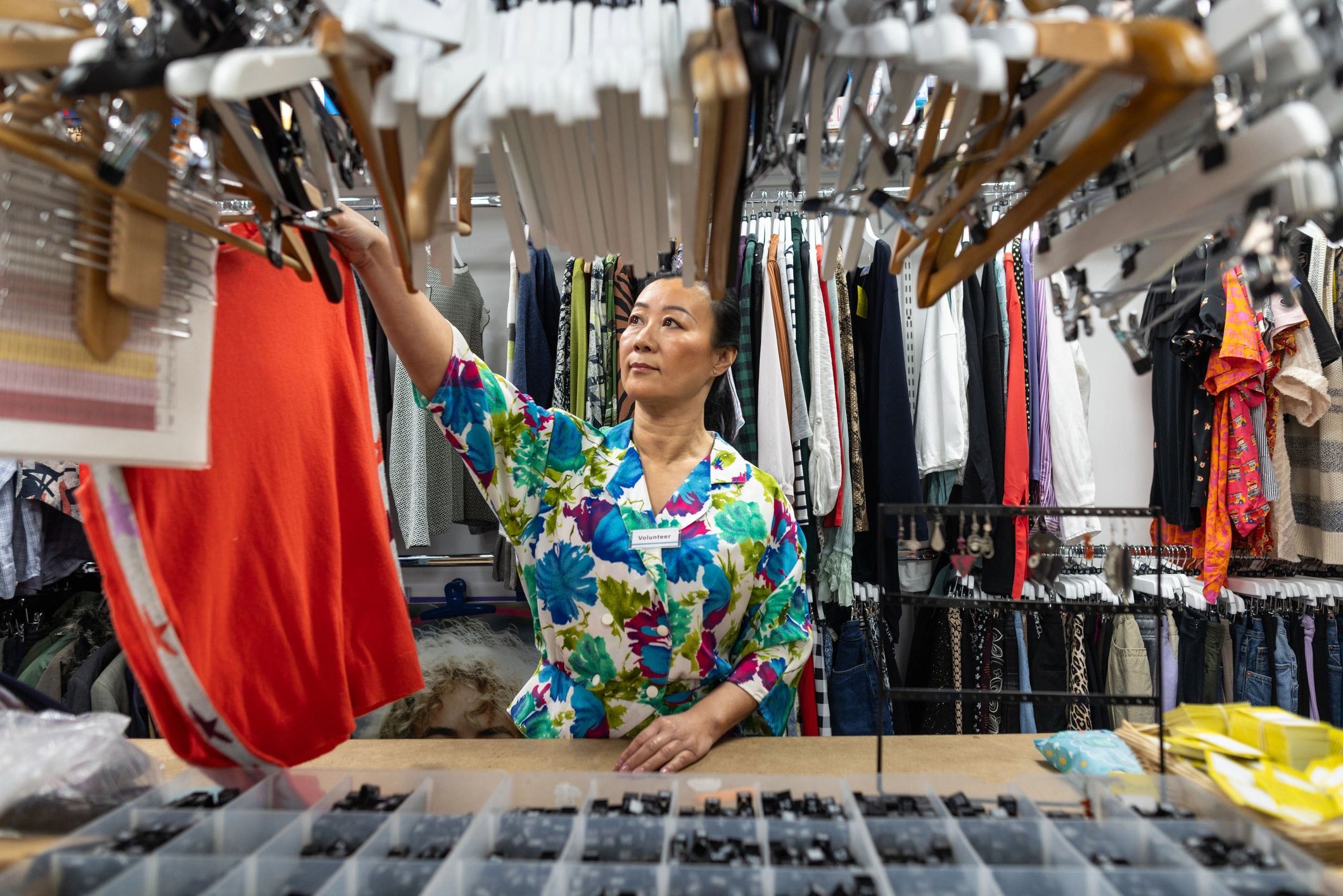 Arranging clothing on a rack in a retail store