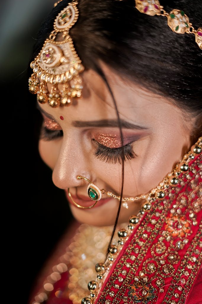 Close-up portrait of a beautifully adorned Indian bride in traditional attire.